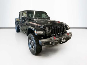 2023 Jeep Gladiator Rubicon 4x4 in a Black Clear Coat exterior color and Dark Saddle/Blackinterior. Sheridan Motors CDJR 307-218-2217 sheridanmotor.com 
