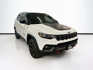 2023 Jeep Compass Trailhawk 4x4 in a Bright White Clear Coat exterior color and Ruby Red/Blackinterior. Sheridan Motors CDJR 307-218-2217 sheridanmotor.com 