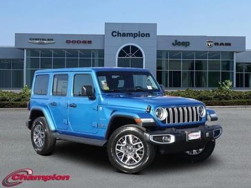 2024 Jeep Wrangler 4-door Sahara in a Hydro Blue Pearl Coat exterior color and CLOTHinterior. Champion Chrysler Jeep Dodge Ram 800-549-1084 pixelmotiondemo.com 