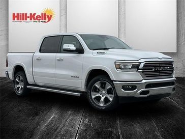 2022 RAM 1500 Laramie in a Ivory White Tri Coat Pearl Coat exterior color and Blackinterior. Hill-Kelly Dodge (850) 786-2130 hillkellydodge.com 