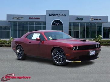 2023 Dodge Challenger Gt in a Octane Red exterior color and HOUNDSTOOTHinterior. Champion Chrysler Jeep Dodge Ram 800-549-1084 pixelmotiondemo.com 