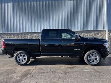 2024 RAM 2500 Big Horn Crew Cab 4x4 6'4' Box in a Diamond Black Crystal Pearl Coat exterior color. Wilmington Auto Center Chrysler Dodge Jeep Ram (937) 556-6430 wilmingtonautocentercdjr.com 