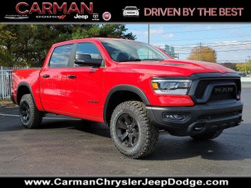 2024 RAM 1500 Rebel Crew Cab 4x4 5'7' Box in a Flame Red Clear Coat exterior color and Black - TLX9interior. Carman Chrysler Jeep Dodge Ram 302-317-2378 carmanchryslerjeepdodge.com 