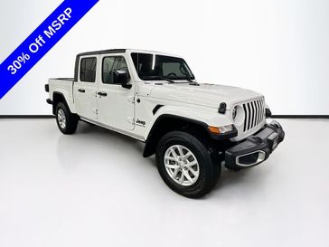 2023 Jeep Gladiator Sport S 4x4 in a Bright White Clear Coat exterior color and Blackinterior. Sheridan Motors CDJR 307-218-2217 sheridanmotor.com 