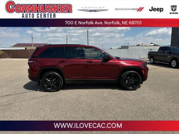 2022 Jeep Grand Cherokee Altitude in a Velvet Red Pearl Coat exterior color and Global Blackinterior. Cornhusker Auto Center 402-866-8665 cornhuskerautocenter.com 