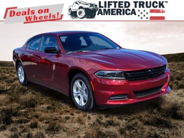 2023 Dodge Charger SXT in a Octane Red Pearl Coat exterior color and Blackinterior. Lifted Truck America 888-267-0644 liftedtruckamerica.com 
