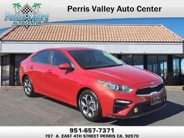 2021 Kia Forte LXS in a Currant Red exterior color and Blackinterior. Perris Valley Chrysler Dodge Jeep Ram 951-355-1970 perrisvalleydodgejeepchrysler.com 