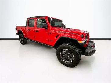 2023 Jeep Gladiator Rubicon 4x4 in a Firecracker Red Clear Coat exterior color and Blackinterior. Sheridan Motors CDJR 307-218-2217 sheridanmotor.com 