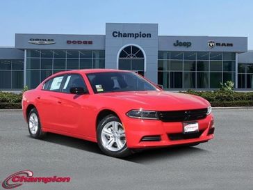 2023 Dodge Charger SXT Rwd in a TorRed exterior color and HOUNDSTOOTHinterior. Champion Chrysler Jeep Dodge Ram 800-549-1084 pixelmotiondemo.com 
