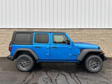 2024 Jeep Wrangler 4-door Sport S in a Hydro Blue Pearl Coat exterior color and Blackinterior. Wilmington Auto Center Chrysler Dodge Jeep Ram (937) 556-6430 wilmingtonautocentercdjr.com 