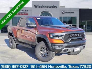 2024 RAM 1500 Trx Crew Cab 4x4 5'7' Box in a Harvest Sunrise exterior color. Wischnewsky Dodge 936-755-5310 wischnewskydodge.com 