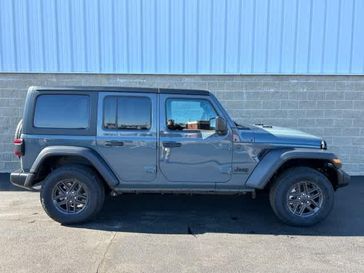 2024 Jeep Wrangler 4-door Sport S in a Anvil Clear Coat exterior color and Blackinterior. Wilmington Auto Center Chrysler Dodge Jeep Ram (937) 556-6430 wilmingtonautocentercdjr.com 