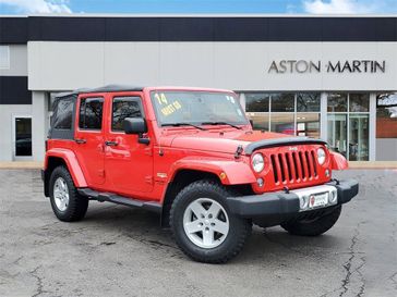 2014 Jeep Wrangler Unlimited Sahara in a Firecracker Red Clear Coat exterior color and Blackinterior. Glenview Luxury Imports 847-904-1233 glenviewluxuryimports.com 