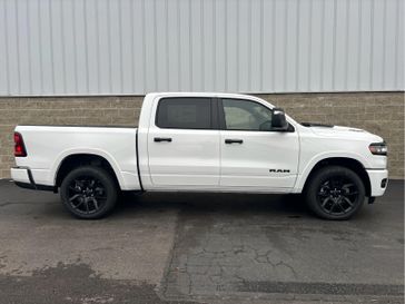 2025 RAM 1500 Laramie Crew Cab 4x4 5'7' Box in a Bright White Clear Coat exterior color. Wilmington Auto Center Chrysler Dodge Jeep Ram (937) 556-6430 wilmingtonautocentercdjr.com 