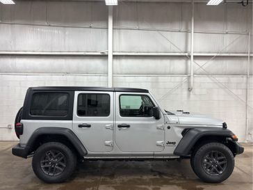 2024 Jeep Wrangler 4-door Sport S in a Silver Zynith Clear Coat exterior color and Blackinterior. Wilmington Auto Center Chrysler Dodge Jeep Ram (937) 556-6430 wilmingtonautocentercdjr.com 