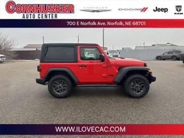 2024 Jeep Wrangler Sport S in a Firecracker Red Clear Coat exterior color and Blackinterior. Cornhusker Auto Center 402-866-8665 cornhuskerautocenter.com 