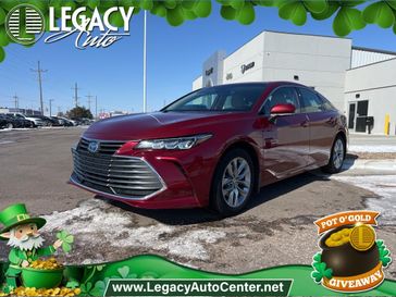 2022 Toyota Avalon XLE Plus in a Ruby Flare Pearl exterior color and Harvest Beigeinterior. Legacy Auto Center 620-315-9264 legacyautocenter.net 