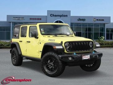 2024 Jeep Wrangler 4-door Willys 4xe in a High Velocity Clear Coat exterior color and CLOTHinterior. Champion Chrysler Jeep Dodge Ram 800-549-1084 pixelmotiondemo.com 