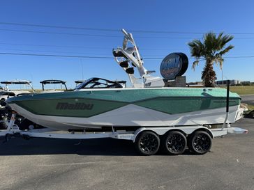 2024 MALIBU WAKESETTER 25 LSV METALLIC GREEN  WHITE  in a GREEN/WHITE exterior color. Family PowerSports (877) 886-1997 familypowersports.com 