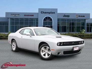 2023 Dodge Challenger SXT in a Triple Nickel exterior color and HOUNDSTOOTH CLOinterior. Champion Chrysler Jeep Dodge Ram 800-549-1084 pixelmotiondemo.com 