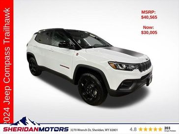 2024 Jeep Compass Trailhawk 4x4 in a Bright White Clear Coat exterior color and Ruby Red/Blackinterior. Sheridan Motors CDJR 307-218-2217 sheridanmotor.com 