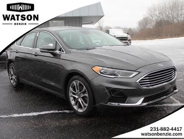 2019 Ford Fusion SEL in a GRAY exterior color and Ebonyinterior. Watson Ludington Chrysler 231-239-6355 