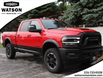 2024 RAM 2500 Rebel Crew Cab 4x4 6'4' Box in a Flame Red Clear Coat exterior color and Blackinterior. Watson Benzie, LLC 231-383-7836 watsonchryslerdodgejeep.com 