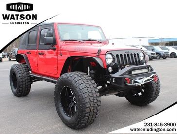 2018 Jeep Wrangler JK Unlimited Willys Wheeler in a Firecracker Red Clear Coat exterior color and Blackinterior. Watson Ludington Chrysler 231-239-6355 