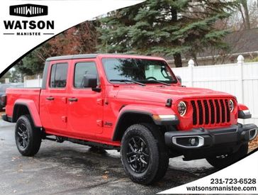 2023 Jeep Gladiator Sport S 4x4 in a Firecracker Red Clear Coat exterior color and Blackinterior. Watson's Manistee Chrysler Inc 231-299-8691 watsonsmanisteechrysler.com 