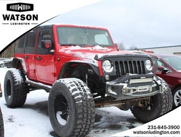 2018 Jeep Wrangler JK Unlimited Willys Wheeler in a Firecracker Red Clear Coat exterior color and Blackinterior. Watson Ludington Chrysler 231-239-6355 