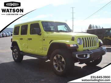 2022 Jeep Wrangler Unlimited Sahara 4x4 in a High Velocity Clear Coat exterior color and Blackinterior. Watson's Manistee Chrysler Inc 231-299-8691 watsonsmanisteechrysler.com 
