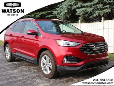 2020 Ford Edge SEL in a Rapid Red Metallic Tinted Clear Coat exterior color and Ebonyinterior. Watson's Manistee Chrysler Inc 231-299-8691 watsonsmanisteechrysler.com 