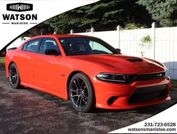 2023 Dodge Charger Scat Pack in a Go Mango exterior color and Blackinterior. Watson Benzie, LLC 231-383-7836 watsonchryslerdodgejeep.com 