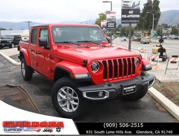 2023 Jeep Gladiator Sport S 4x4 in a Firecracker Red Clear Coat exterior color. Glendora Chrysler Dodge Jeep Ram 909-506-2515 glendorachryslerjeepdodge.com 