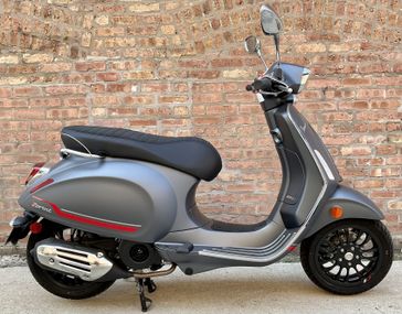 2023 Vespa Sprint 50 Sport   in a Grigio Travologente exterior color. Motoworks Chicago 312-738-4269 motoworkschicago.com 