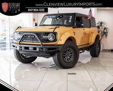 2021 Ford Bronco First Edition in a Cyber Orange Metallic Tri Coat exterior color and Roastinterior. Glenview Luxury Imports 847-904-1233 glenviewluxuryimports.com 