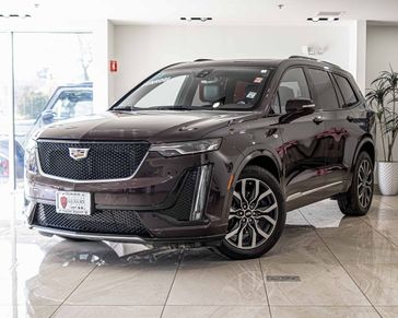 2021 Cadillac XT6 Sport in a Red exterior color and Cirrus/Jet Black Accentsinterior. Glenview Luxury Imports 847-904-1233 glenviewluxuryimports.com 