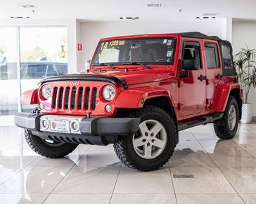2014 Jeep Wrangler JK Unlimited Sahara in a Firecracker Red Clear Coat exterior color and Blackinterior. Aston Martin of Glenview 847-904-1233 astonmartinofglenview.com 