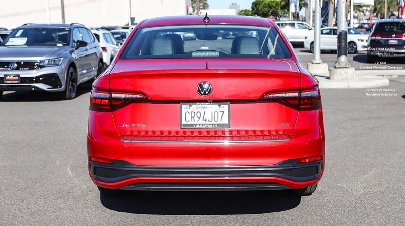 2023 Volkswagen Jetta SE in a Kings Red Metallic exterior color and Titan Blackinterior. BEACH BLVD OF CARS beachblvdofcars.com 