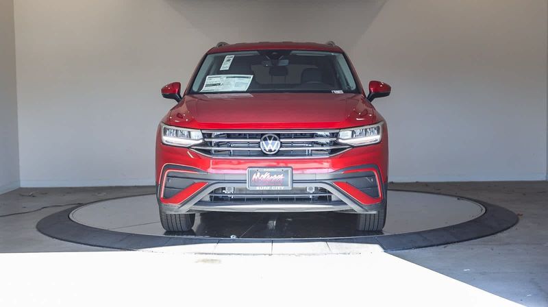 2023 Volkswagen Tiguan SE in a Kings Red Metallic exterior color and Titan Blackinterior. BEACH BLVD OF CARS beachblvdofcars.com 