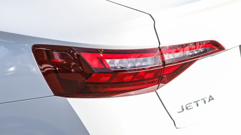 2024 Volkswagen Jetta SE in a Opal White Pearl exterior color and Titan Blackinterior. BEACH BLVD OF CARS beachblvdofcars.com 