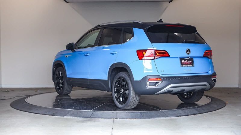 2024 Volkswagen Taos SE in a Cornflower Blue w/Deep Black Roof exterior color and Blackinterior. BEACH BLVD OF CARS beachblvdofcars.com 