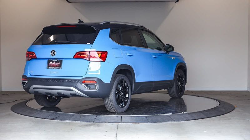 2024 Volkswagen Taos SE in a Cornflower Blue w/Deep Black Roof exterior color and Blackinterior. BEACH BLVD OF CARS beachblvdofcars.com 