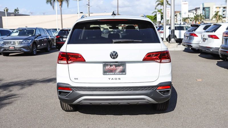 2024 Volkswagen Taos SE in a White exterior color. BEACH BLVD OF CARS beachblvdofcars.com 