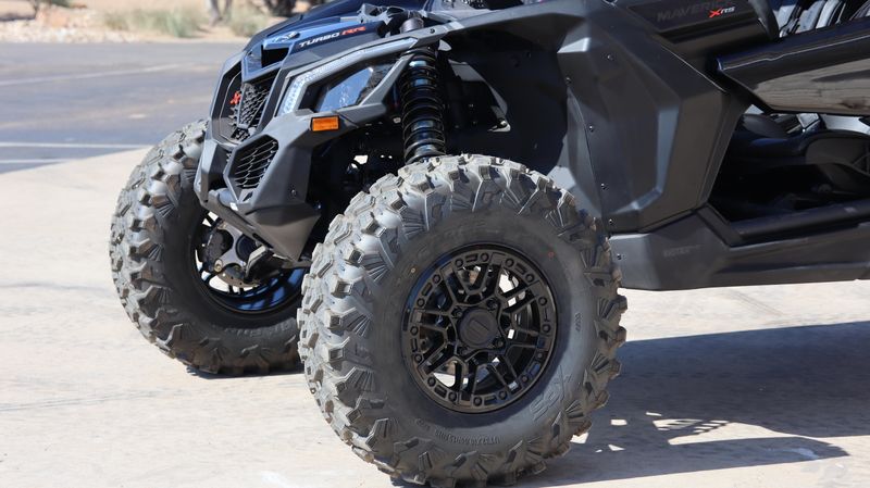 2025 CAN-AM MAVERICK X3 MAX X RS TURBO RR WITH SMARTSHOX TRIPLE BLACK in a TRIPLE BLACK exterior color. Family PowerSports (877) 886-1997 familypowersports.com 