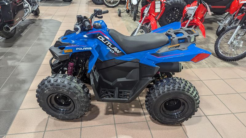 2025 POLARIS OUTLAW 70 EFI  VELOCITY BLUE AND FIERCE FUCHSIA in a VELOCITY BLUE AND FIERCE FUCHSIA exterior color. Family PowerSports (877) 886-1997 familypowersports.com 