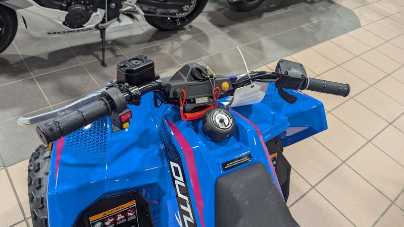 2025 POLARIS OUTLAW 70 EFI  VELOCITY BLUE AND FIERCE FUCHSIA in a VELOCITY BLUE AND FIERCE FUCHSIA exterior color. Family PowerSports (877) 886-1997 familypowersports.com 