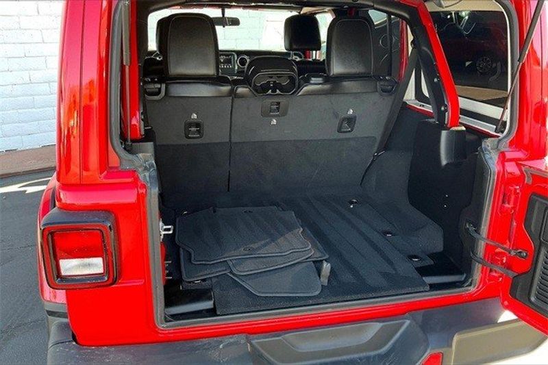 2021 Jeep Wrangler Unlimited Sahara Altitude in a Firecracker Red Clear Coat exterior color and Blackinterior. Crystal Chrysler Jeep Dodge Ram (760) 507-2975 pixelmotiondemo.com 