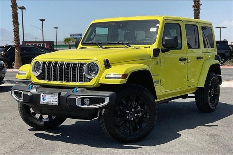 2024 Jeep Wrangler 4-door Sahara 4xe in a High Velocity Clear Coat exterior color and Blackinterior. I-10 Chrysler Dodge Jeep Ram (760) 565-5160 pixelmotiondemo.com 