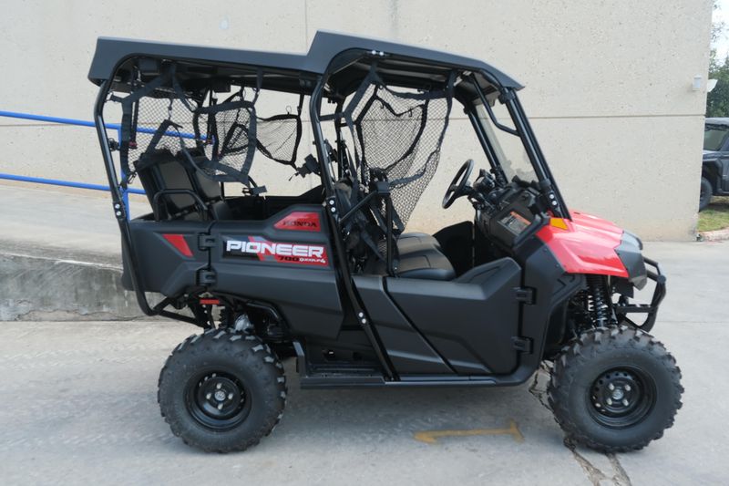 NEW 2026 HONDA PIONEER 7004  in a HERO RED exterior color. Family PowerSports (877) 886-1997 familypowersports.com